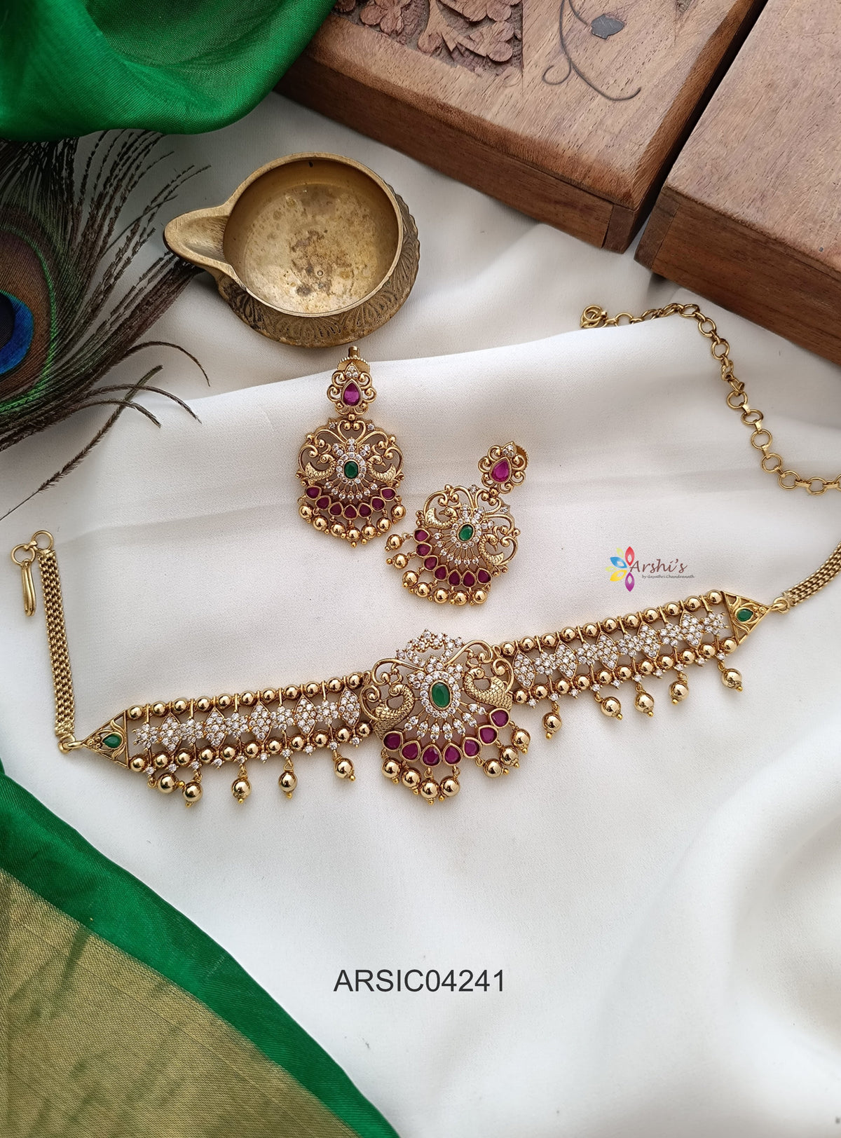 the earrings should be in center of the necklace